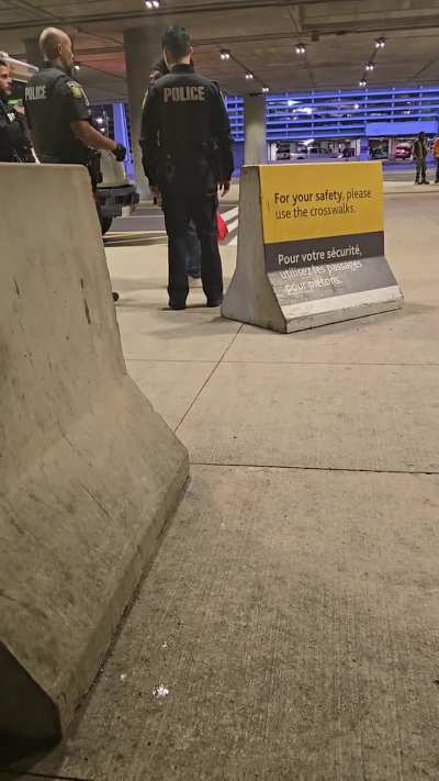 Kenyan (or Nigerian) woman at an airport in Toronto throwing a hissy fit because she can't fly and is being escorted by police