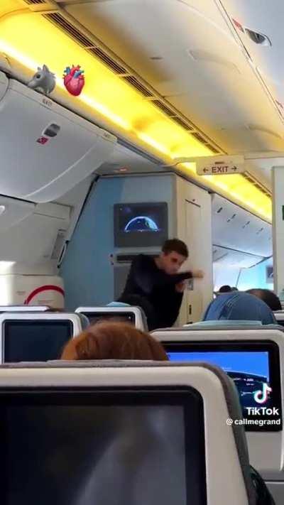 Dumbfuck tries to impress the ladies by shadowboxing inside a plane