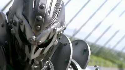 Kamen Rider Blade walks through gunfire.