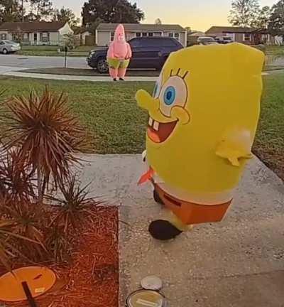 This kid struggling to open a door in a SpongeBob costume.