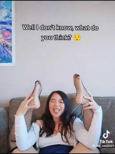 Asian with legs above head showing off her soles