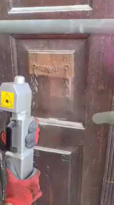 Cleaning old door with a laser gun