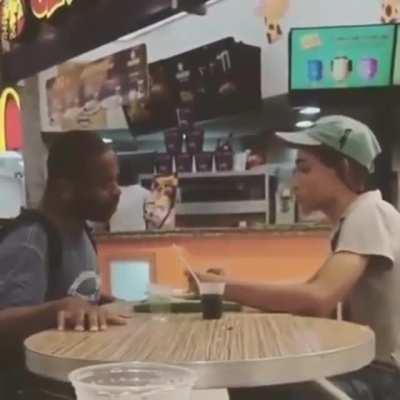 McDonald's employees helping a disabled man eat so he doesn't have to do it himself