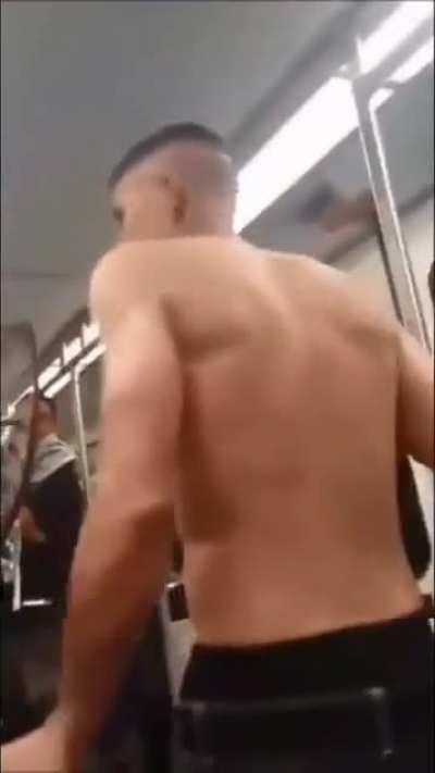 Shirtless man on train gets choked out my captain America.