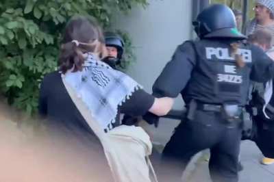 At an anti-genocide rally in Germany a young woman protestor is violently tackled by Berlin police