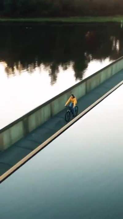 There is a bike trail in Belgium where you can go “Cycling Through Water,” through a large lake in the De Wijers nature reserve. This bridge is below the water line and in parts it is low enough to put riders at eye level with the lake.