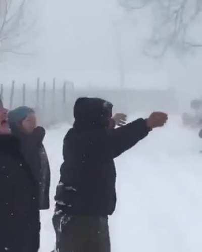 Babushkas calling for their friend to come out and play in the snow