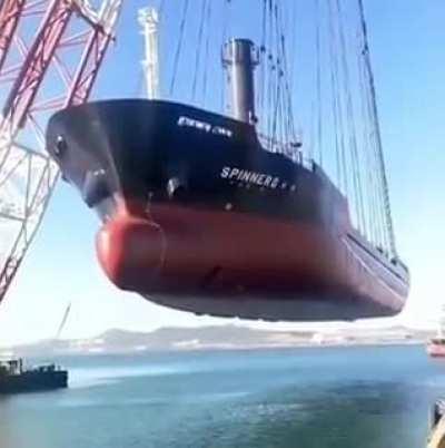 The world's largest floating crane Hyundai 10000 carrying a giant ship