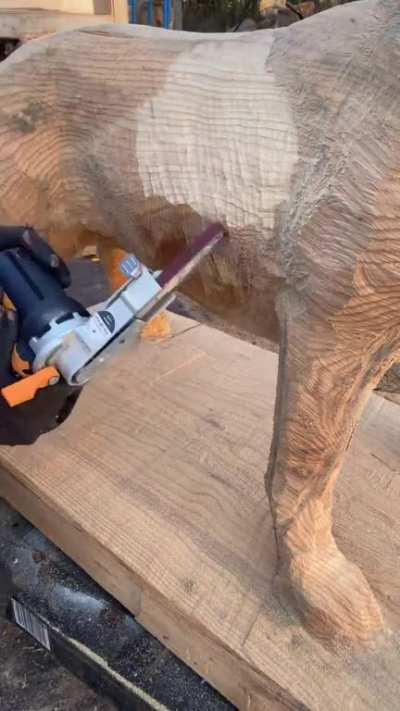 Carving big tree trunks to look like people’s dogs who have passed away