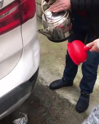 Using boiling water and a plunger to remove car dents