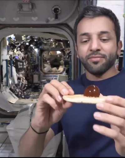 UAE astronaut eating bread and honey in space