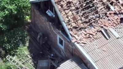 Russian soldier throws a mine into a house. The mine blasts the house into rubble, together with the thrower.