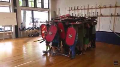 Kids demonstrating the effectiveness of the Roman testudo formation