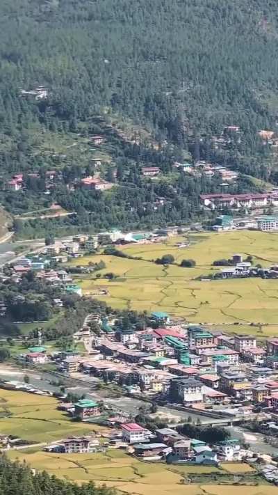 Mountainside Bird's Eye View of a Plane landing into Paro Airport, Bhutan