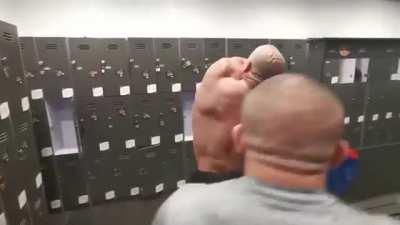 Bodybuilder can’t reach the sticker on his back