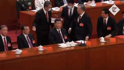 Former Chinese leader Hu Jintao unexpectedly led out of room as Party Congress comes to a close