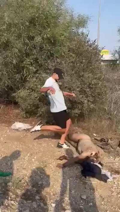 NSFW: Israeli soldiers after executing civilians by the roadside 