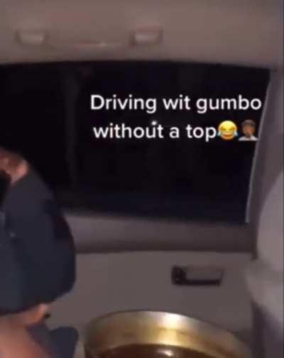 Who let this man in the car with a topless pot of gumbo