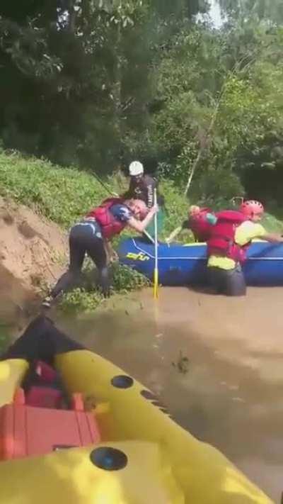 Launching an inflatable raft off a river bank