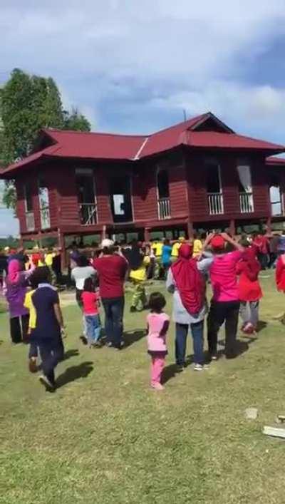 These people carrying a whole house on their shoulders