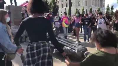 Historic moment in Minnesota as Native Americans, allies, &amp;amp; a cute doggo dance around the fallen statue of Christopher Columbus