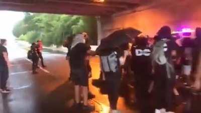 Protesters attempt to pull a man out of his car as they block roads in DC