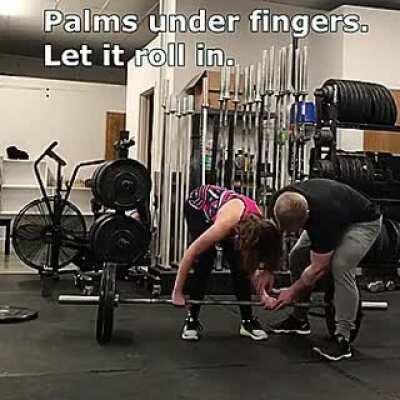 Gym guy teaching blind woman how to deadlift