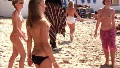 The Trouble with Spies (1987), PG-13, Uncredited topless women at the beach (boobs and ass)