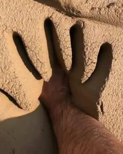 Pushing your hand into soft mud