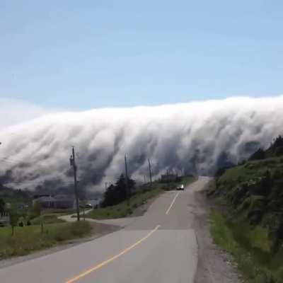 Cloud waterfall over Long Range Mountains in Lark Harbour, Newfoundland, Canada.