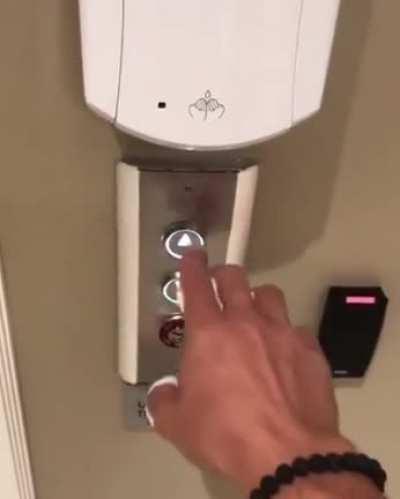 Some genius installed an automatic hand sanitiser over the elevator button