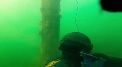 Divers of the 73rd SOF Maritime Center performing underwater tasks