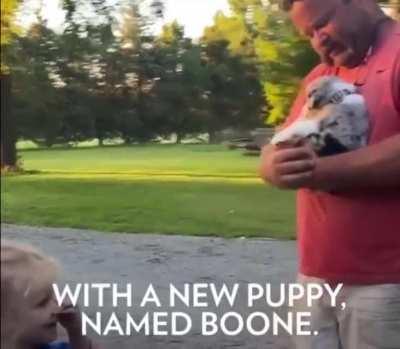 Man's family surprised him with a new puppy.