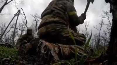 Ukrainian soldiers chop down tree to recover stuck drone while under artillery shelling