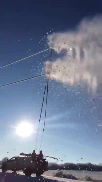 Scraping ice off power lines