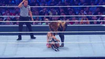 Nia Jax grabs the unconscious Alexa Bliss by her hair