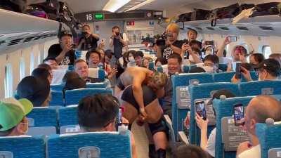 Japanese Wrestlers have a match on a train