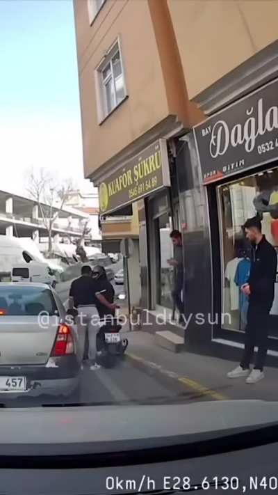 A man throws a bottle to a stray cat in Turkey