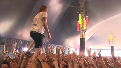 Singer of Dutch band &quot;John Coffey&quot; catches a cup of beer thrown from crowd