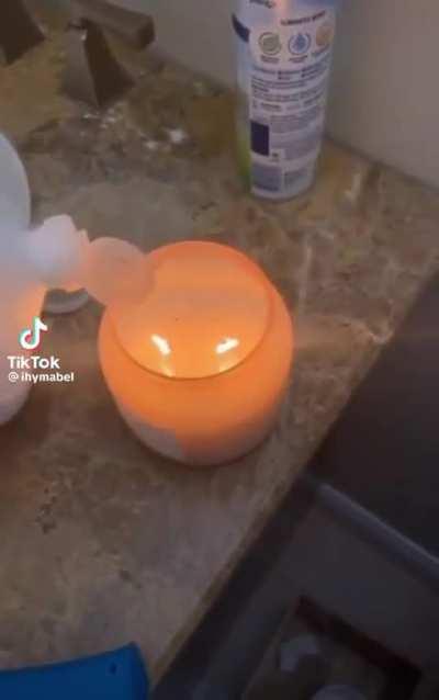 Pouring rubbing alcohol in a candle