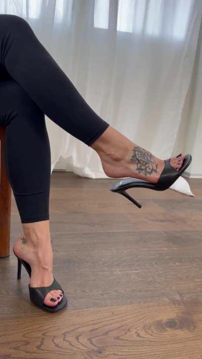 Black toe nails, dangling high heels - a match made in footwear heaven.