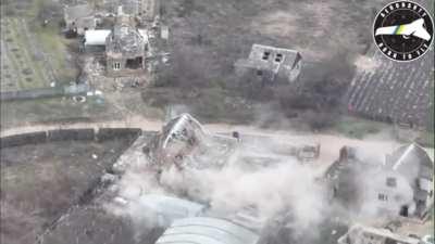 A house with Russian soldiers inside takes a direct hit and collapses.