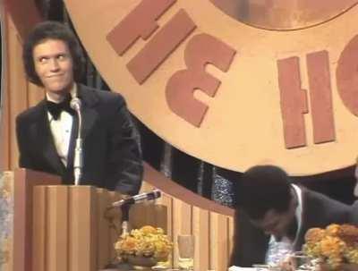 Billy Crystal does an unbelievable impression of Muhammad Ali, while Ali, who's sitting right beside him, cries from laughter, 1976.