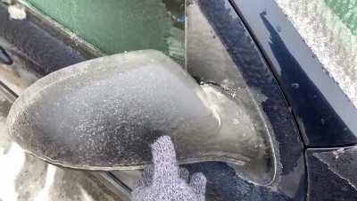 Peeling off ice frozen on this car