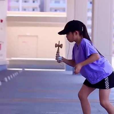 Yui playing with a Japanese kendama