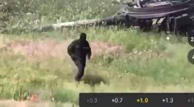 Russian hiding under tank gets hit with FPV, comes out covered in soot