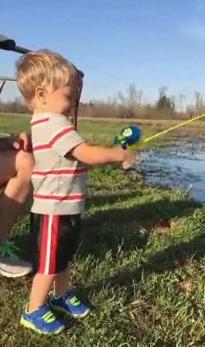 Kid catches fish with toy fishing rod