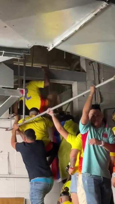 Soccer fans entering the Copa America match through the ventilation system of the stadium 