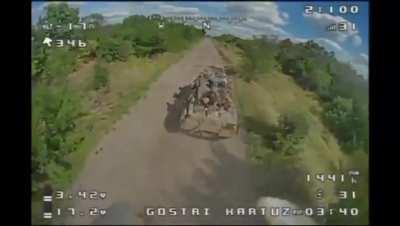 Footage of Ukrainian FPV kamikaze drone strike on Russian infantry riding on top of a BTR.