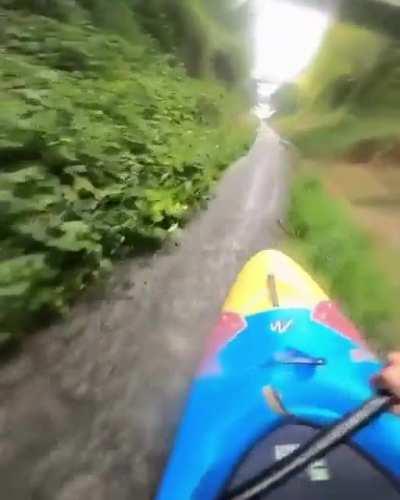 Guy does canoeing on a thin wet grass strip with insane control and precision